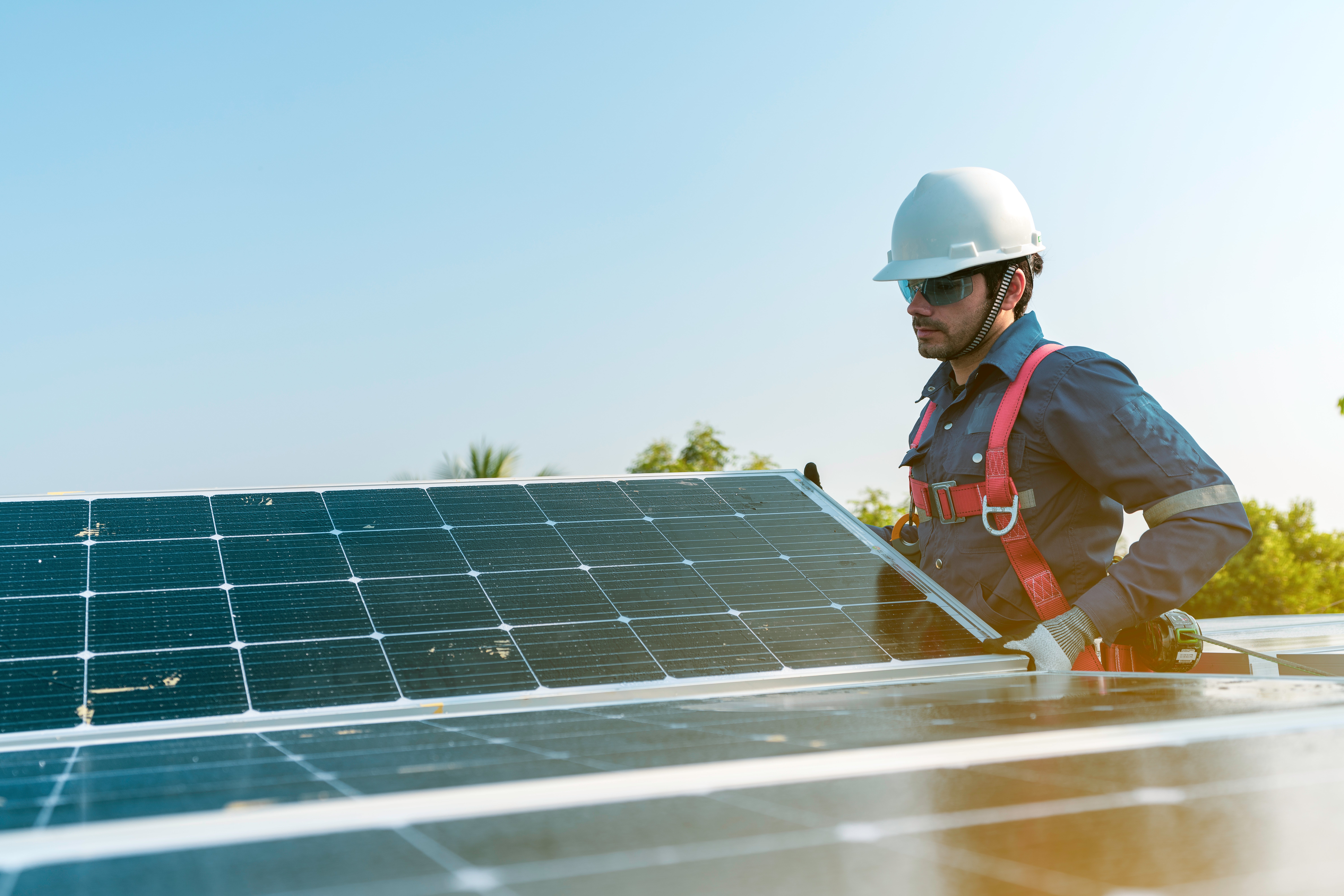 man working solar panels